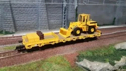 Kibri 26274 Flat wagon with axles, backhoe loader, and construction...